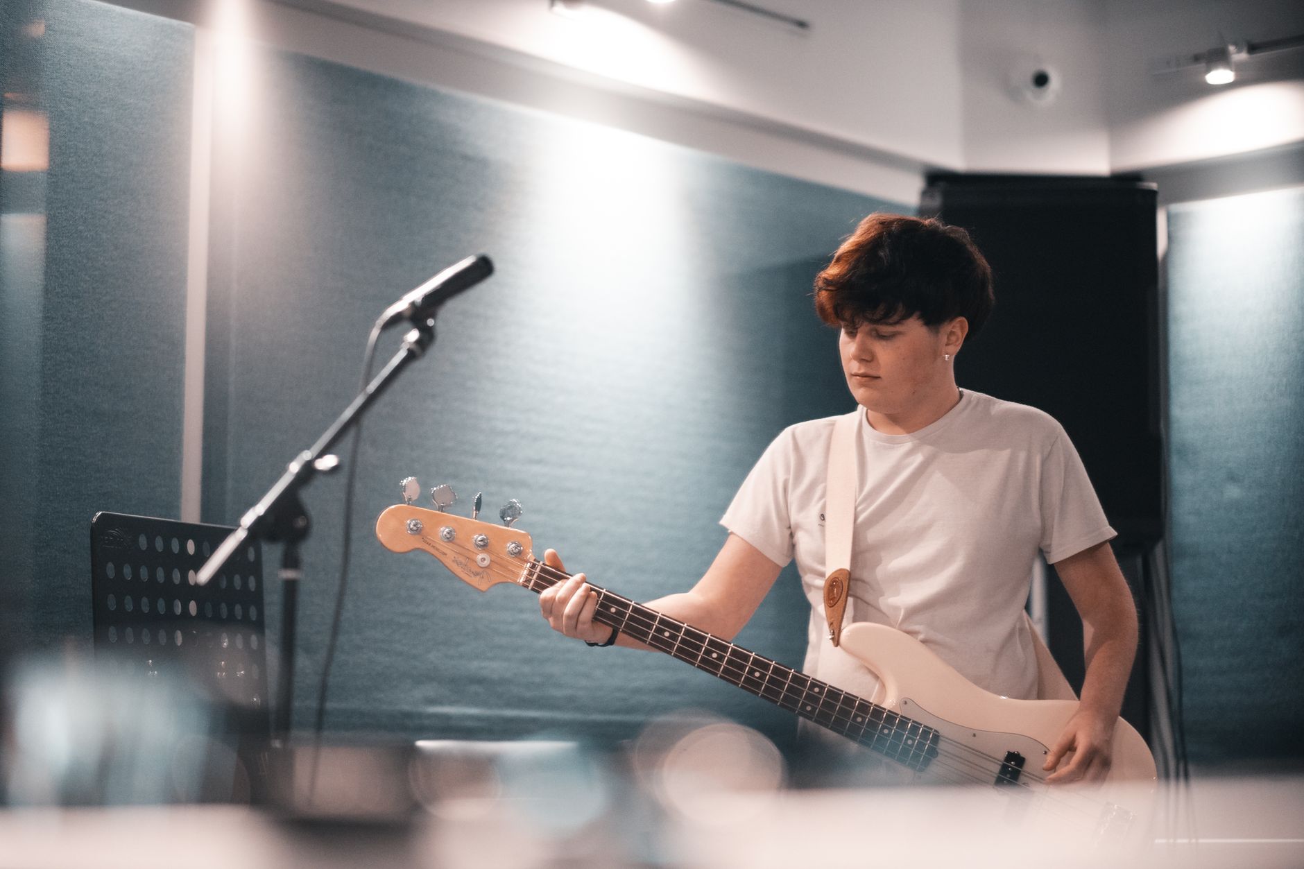A young person in a music studio